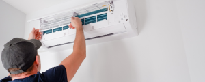 Technician repairing white air conditioner unit